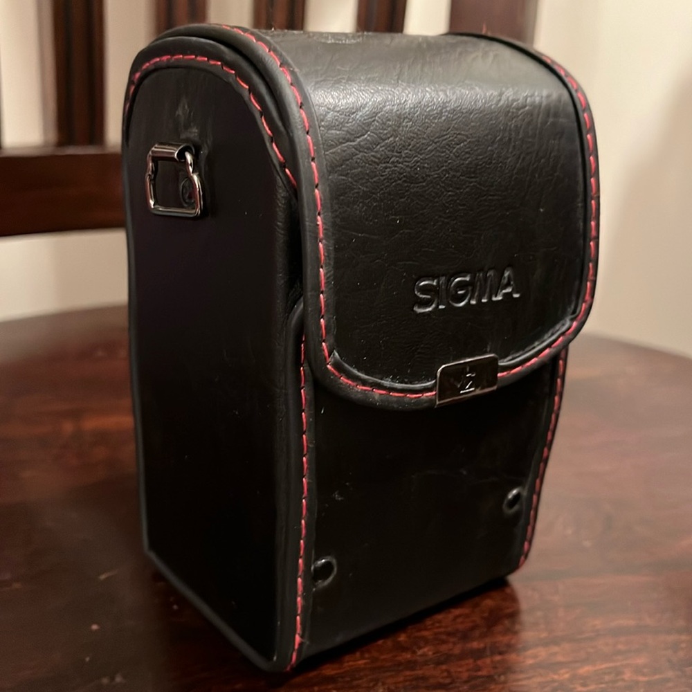 Sturdy Sigma camera lense case, structured, snap closure